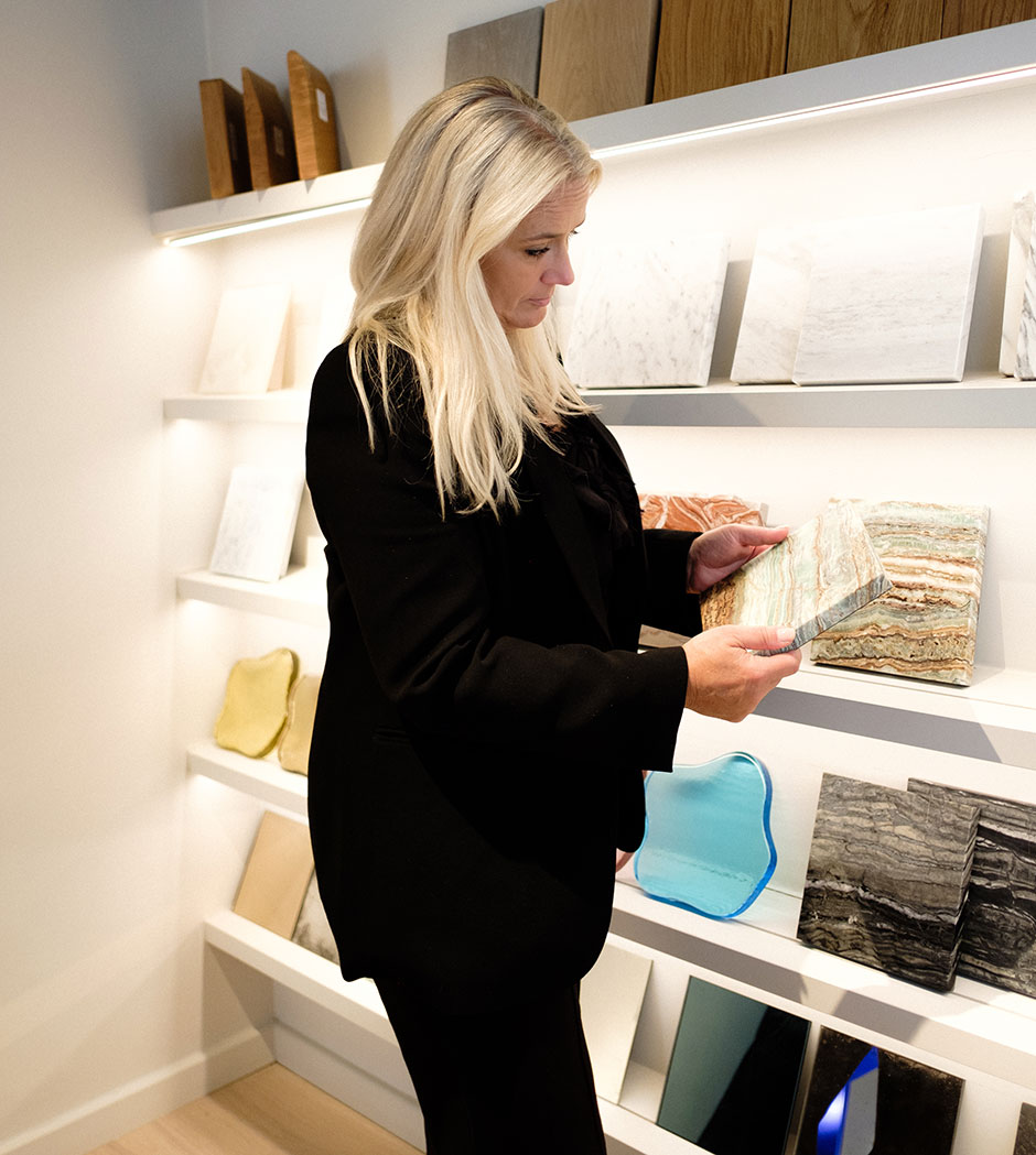 Elie Jones selecting tile samples as part of a custom interior design process